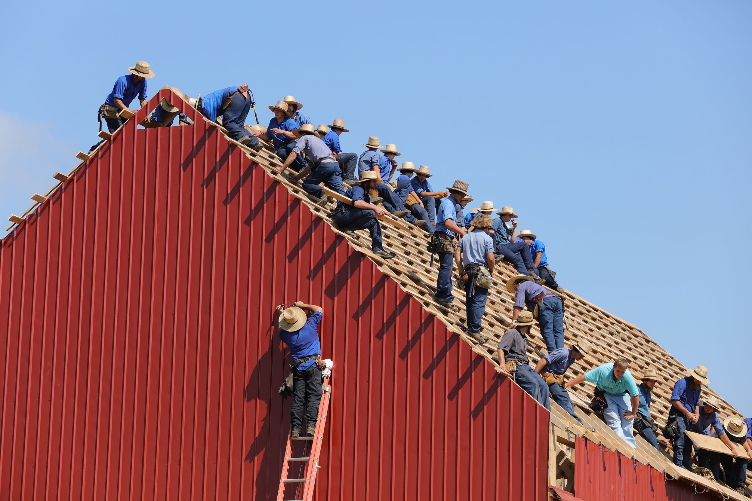 Photo of Amish men roofing a house by Randy Fath