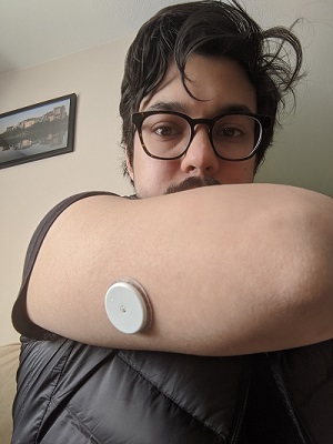 A continuous glucose monitor on my arm