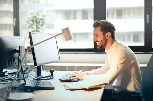 happy office worker Photo by Andrea Piacquadio from Pexels